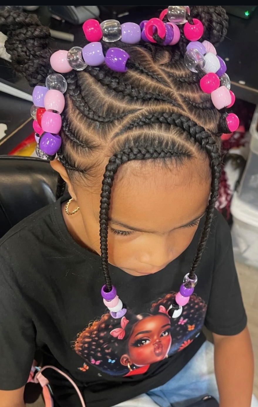 Young girl with beautifully braided hair adorned with colorful pink and purple beads